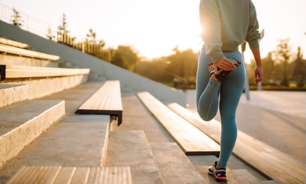 bežkyňa si naťahuje stehenný sval